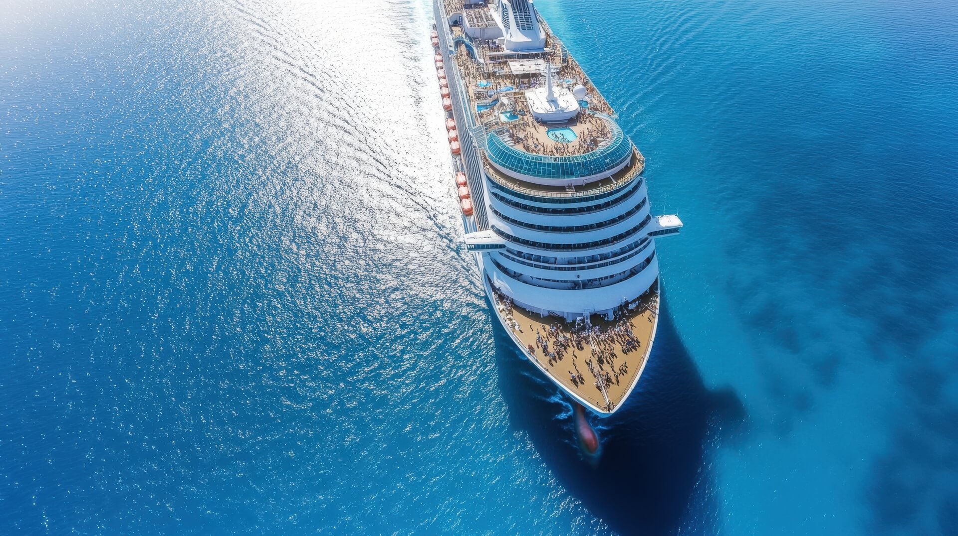 medium-vecteezy_cruise-ship-sailing-on-ocean-surface-aerial-view-vacation_68854663_medium (1)